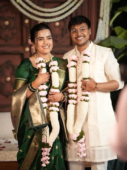 Another beautiful shot of the happy couple holding their custom crochet varmalas. I designed these with soft white and pink yarn to match their wedding theme, creating a lasting piece of art from their ceremony.