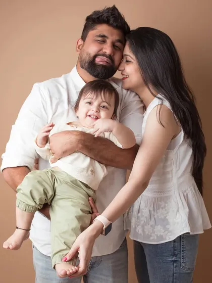 A candid moment of affection. This family portrait captures a sweet, unscripted interaction that is full of warmth and genuine love.