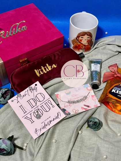 These velvet bridesmaid boxes are pure luxury. Each box is personalised with the bridesmaid's name and filled with a custom mug, eye mask, hand cream, chocolates, and a beautiful bracelet.