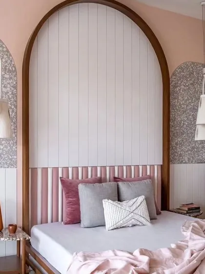 For this bedroom, I created a custom arched headboard with integrated vertical paneling and an upholstered base. This adds a distinct design element while helping to soften room acoustics.