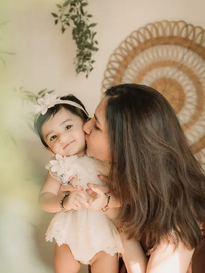 A close-up of a mother's gentle kiss on her daughter's cheek. So much love in one photo.