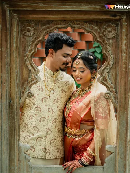 A beautifully framed couple portrait, showcasing their traditional attire and her radiant look.