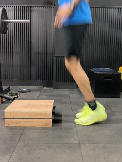 An athlete performing quick feet drills on a box. This enhances foot speed, ankle stiffness, and reactive ability, which are all crucial for agility.