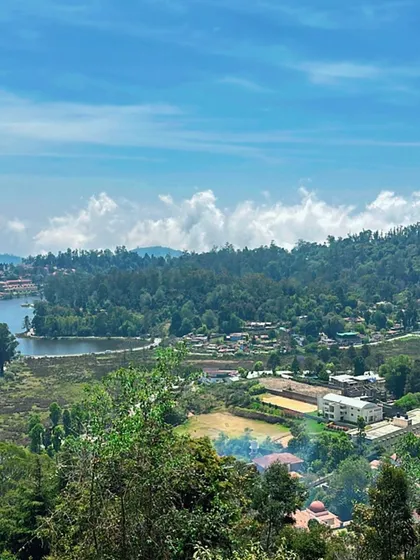 A scenic view of Kodaikanal town and lake from a viewpoint.