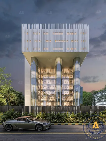 A frontal view of Joy Tower, Noida, where a modern commercial facade is defined by its elevated structure and glass-encased columns. The design is a bold statement of innovation and contemporary architecture.