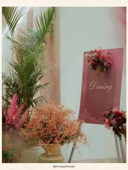 A simple and elegant "Dining" sign, adorned with small floral bouquets, guiding guests in a stylish and understated way.