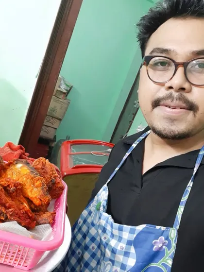 The chef on duty, proud to be serving up delicious fried chicken.