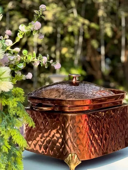An elegant copper chafing dish, part of my premium serveware collection. These small details in presentation contribute to the overall luxurious feel of the events I cater.