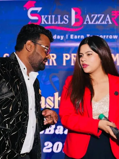 A candid moment of discussion with a co-host or event organizer. Teamwork makes the dream work.