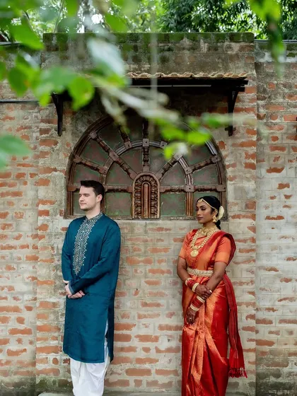 The anticipation of the first look. The couple stands on either side of a wall, a creative and emotional shot before the big reveal.
