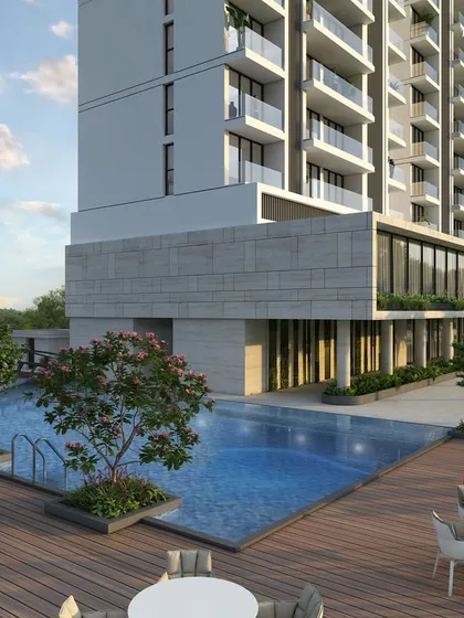 The poolside deck at our twin tower project in Nashik. The expansive amenity space includes a large pool, comfortable seating, and lush landscaping, designed to cater to every whim of a luxurious lifestyle.