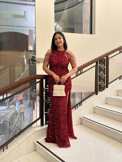 For a friend's cocktail night, I chose this stunning red sequin gown. The silhouette is classic and glamorous, with beaded shoulder details adding a modern, unique touch.