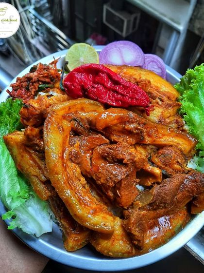 A platter dedicated to pork lovers, featuring large pieces of savory pork with fresh lettuce and king chili.