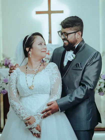 A beautiful portrait of the couple inside the church after the ceremony, their smiles reflecting the joy of their union.