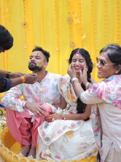 Capturing the joy of a Haldi ceremony. This candid shot shows the couple enjoying their ritual, with makeup that is both radiant and durable enough to withstand all the fun and emotions of the day.