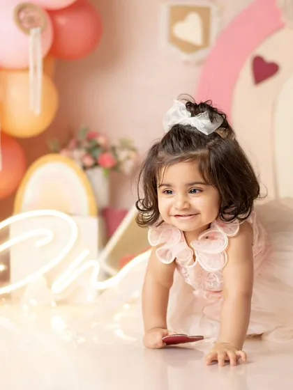 This little princess is on the move, crawling through her beautiful first birthday setup.