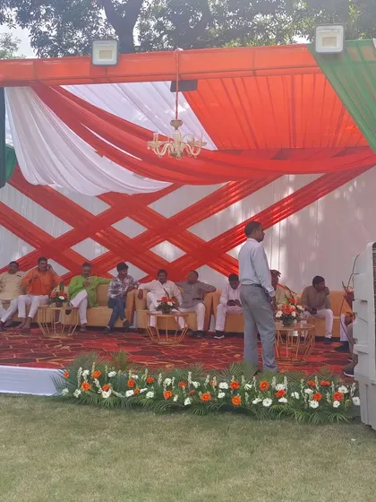 This is a VIP lounge area I set up inside a tent for a political event. It features tricolor fabric draping, plush sofas for dignitaries, and practical additions like air coolers to ensure comfort.