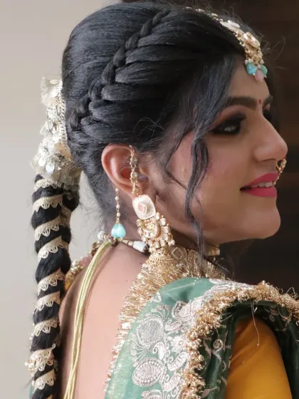 A side profile showcasing the elegant hair updo and the detailed earring, or 'jhumki'.