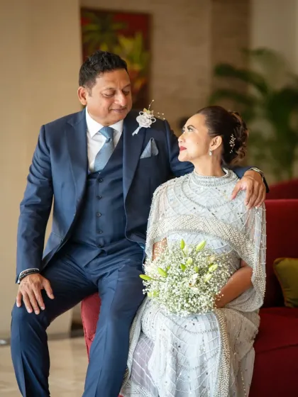 A beautiful portrait from a silver wedding anniversary celebration. Their comfortable embrace and happy expressions show a love that has stood the test of time.