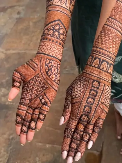 A very clean and intricate design with a focus on geometric checks and delicate floral borders.