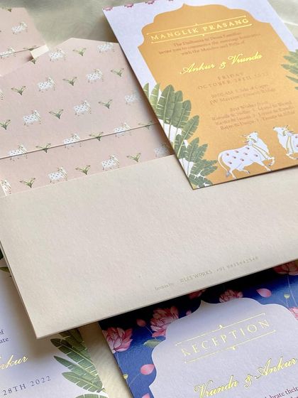A detail of an invitation suite showing the custom-printed envelope liner. The liner features a pattern of Pichhwai-style cows, a delightful surprise for guests as they open the invitation.