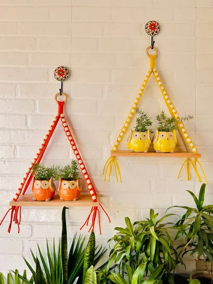 A vibrant display of our macrame and beads wall shelves in crimson red and ocean blue. Paired with our ceramic owl planters, they create a cheerful and stylish look for any wall.