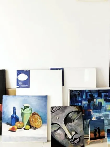 Another view of my art collection and supplies. This is my creative sanctuary, filled with oil paints, acrylics, brushes, and original artworks.