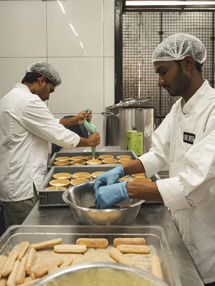 Our pastry chefs at work, preparing batches of our Tiramisu and other desserts.