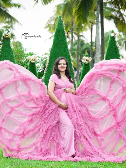 A stunning butterfly pose with a pink ruffled gown, creating a beautiful and dramatic effect.