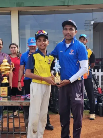 An award winner from the U-12/U-14 tournament poses with his coach, showcasing the strong mentor-student bond we cultivate.