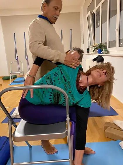 Providing a gentle, hands-on adjustment to a student in Geneva. I believe in giving personal attention to each practitioner, ensuring they practice safely and effectively, no matter their level of experience.