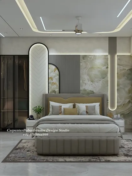 This master bedroom features a stunning headboard wall with a mix of green marble, fluted panels, and a unique herringbone pattern. The design is rich, textured, and luxurious.