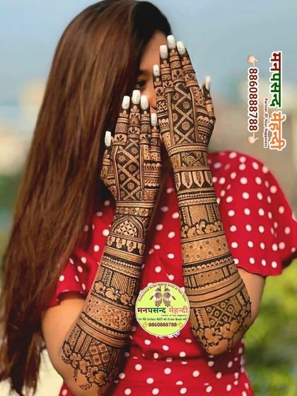 A client showing off her intricate full-arm mehndi design. Her pose shows how confident and happy she feels with her henna.