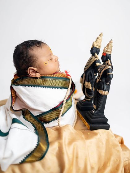 A slightly different angle of the color Warkari setup, showing the delicate pearl necklace and the texture of the golden silk cloth.
