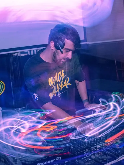 A long-exposure shot creating light trails around me at the console. This artistic photo captures the flow of energy and music.