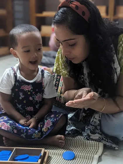 As a guide, your role is not to instruct, but to connect. Here, a teacher shares a moment of discovery with a child using geometric shape insets. You will learn how to facilitate these joyful interactions that spark a child's natural curiosity and love for learning.
