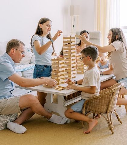 A family playing a game of Jenga together. Lifestyle sessions are about capturing the activities you love to do as a family.