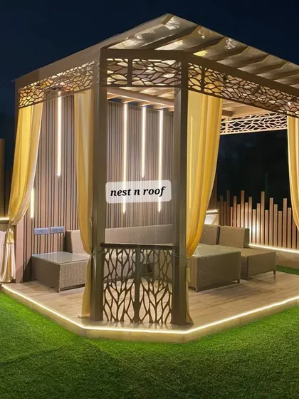 This elegant gazebo is the centerpiece of a beautiful terrace garden. We designed it with intricate laser-cut panels and flowing curtains, creating a private and luxurious outdoor seating area perfect for any weather.