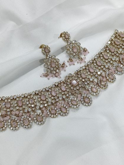 A beautiful choker set with a delicate design, shown in multiple pastel colors including grey, pink, and mint green.