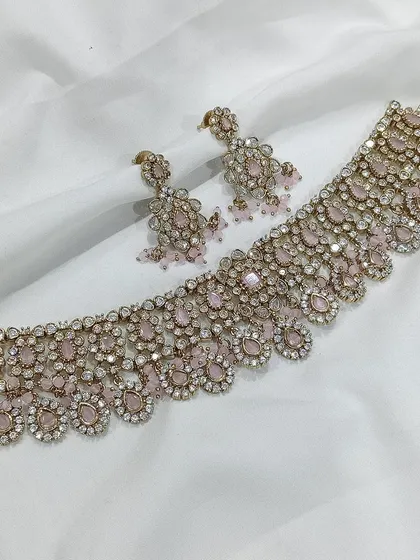 A pink stone choker with an antique finish.