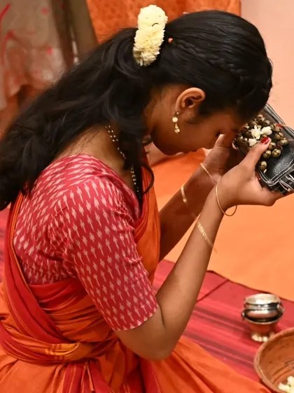 My shishya reverently takes the blessed ghungroos to her forehead. This act symbolizes her acceptance of the responsibility and joy of carrying the tradition forward.