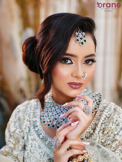 A close-up that showcases the flawless base, winged eyeliner, and beautifully manicured nails.