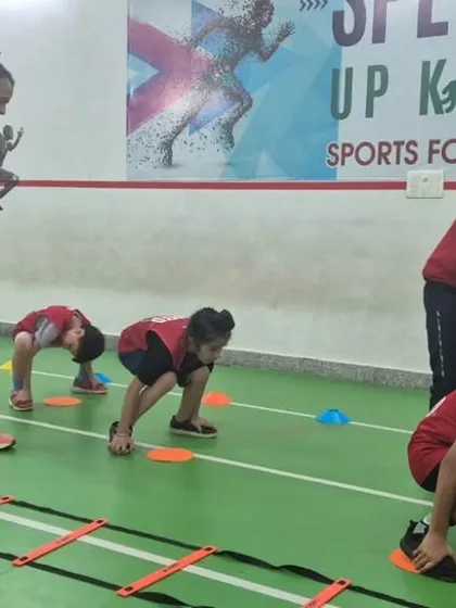 A full view of our agility training setup. Kids work their way through ladders and markers, building speed and coordination under the watchful eyes of our coaching team.