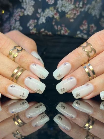 A full view of the white and silver foil flake nails.