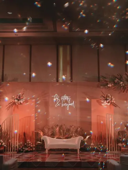 A dreamy, atmospheric shot of the engagement stage, with the chandeliers creating a beautiful bokeh effect.