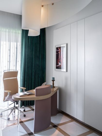 A girl's dream study sanctuary. This custom-crafted space features a stunning acrylic-legged desk, a bespoke light fixture, and a chequered floor, making every detail a gem.