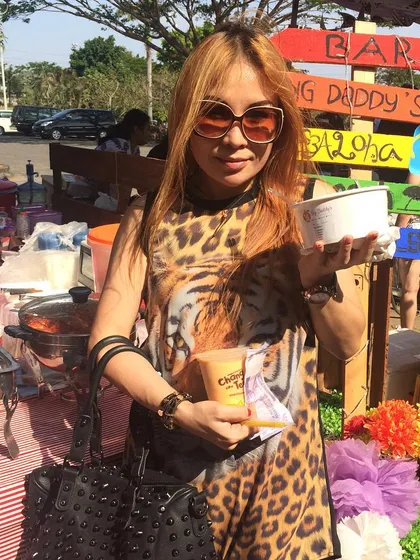 A happy customer enjoying the sunshine at our outdoor stall. Thank you for coming!