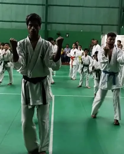 Senior and junior students practicing their basic stances and punches during a belt exam. Fundamentals are the core of our teaching.