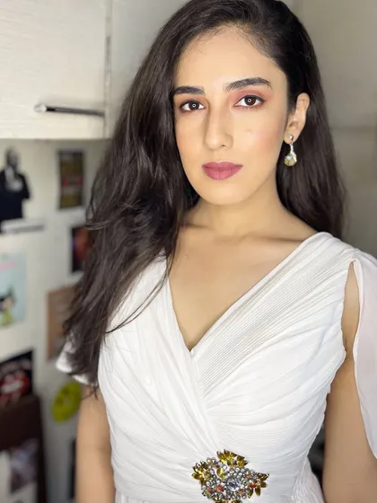 A portrait from the white dress shoot. The makeup is subtle, enhancing her natural features for a clean and sophisticated look.