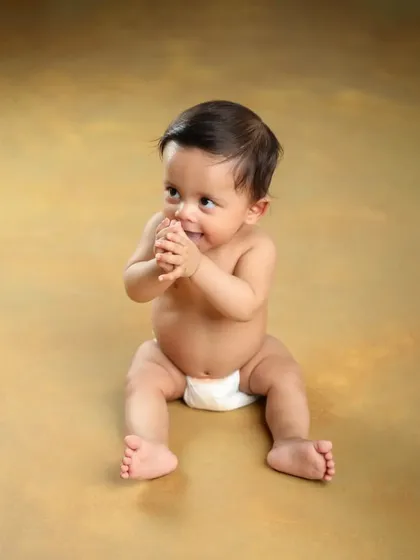 Such a handsome little man. His playful expression and clasped hands are just too cute.